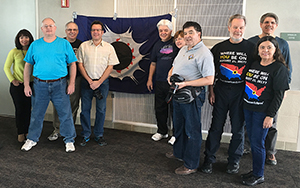 Before Flight 870 departed Anchorage, eclipse chasers gathered with Craig Small's lucky eclipse flag, which has accompanied him on every viewing expedition since 1973. He's seen 31.