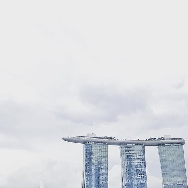 A photo of three buildings with a long structure on top.