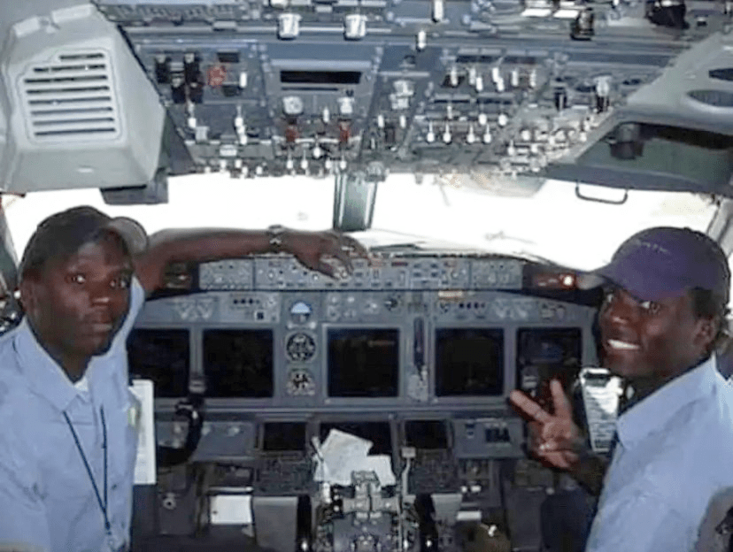 The brothers sitting in a flight deck around age 13.