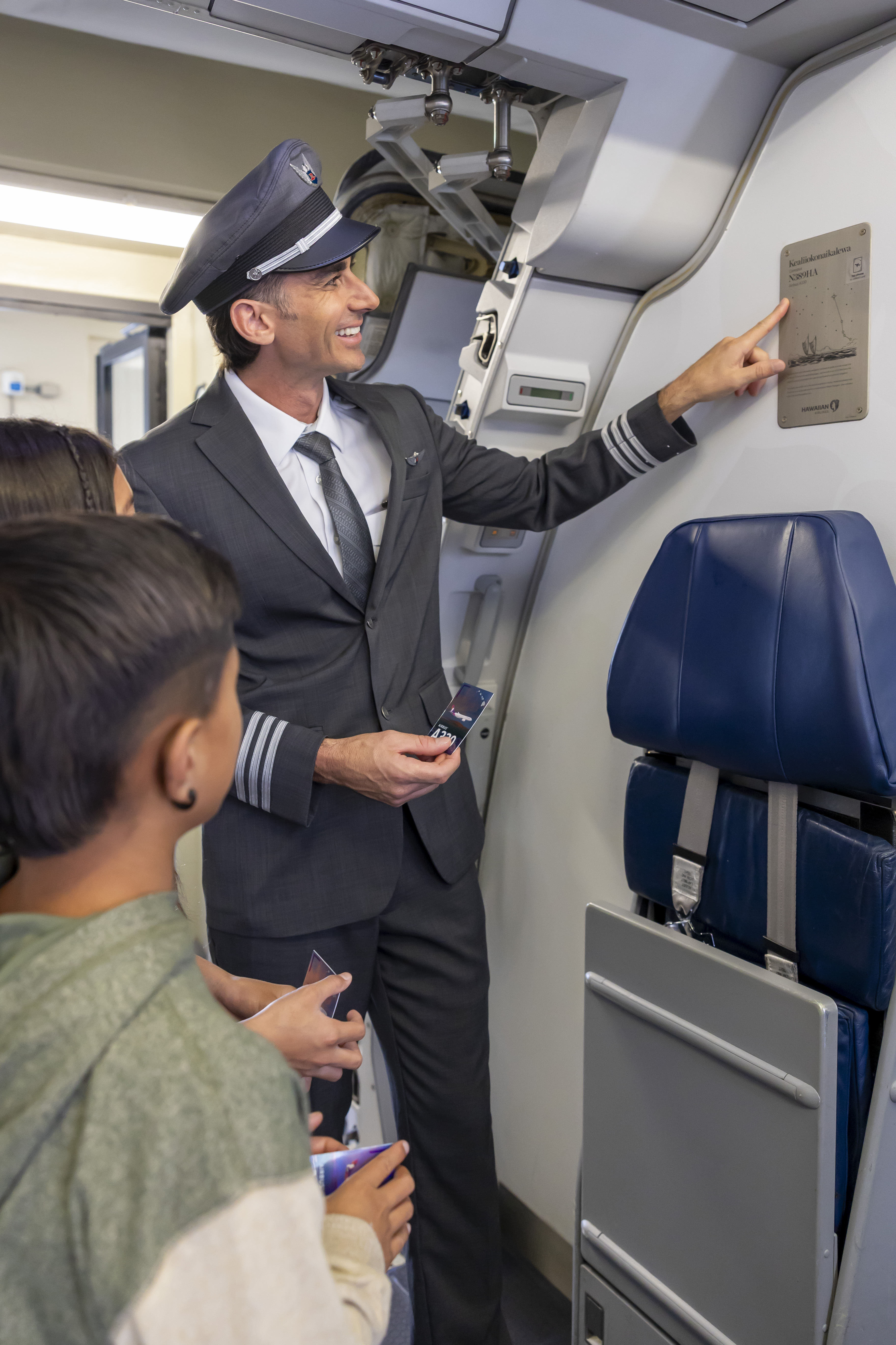 Pilot pointing to Hawaiian Airlines aircraft name plate with NFC tag