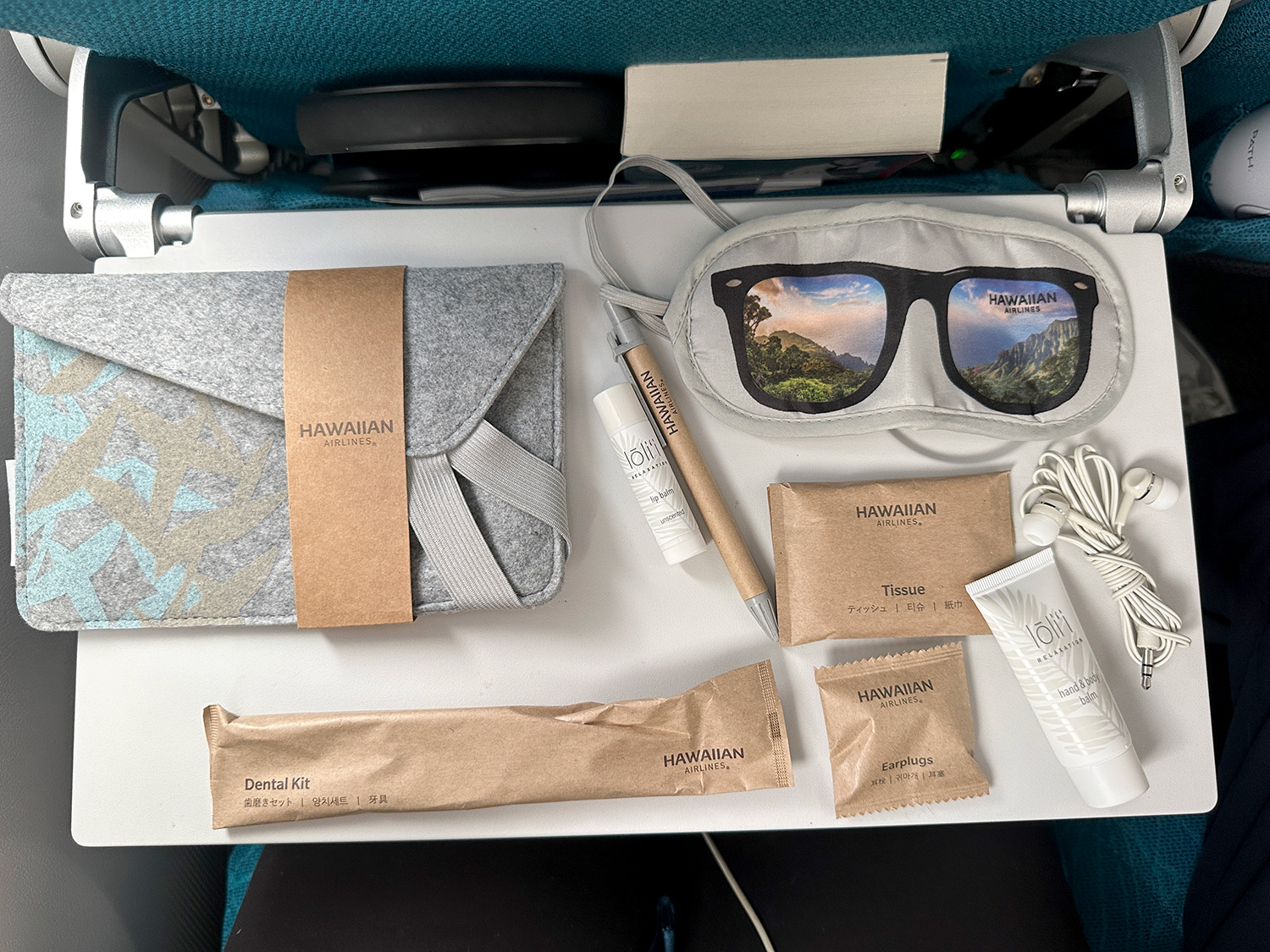 Extra comfort amenity kit items, shown on the seat's tray table.