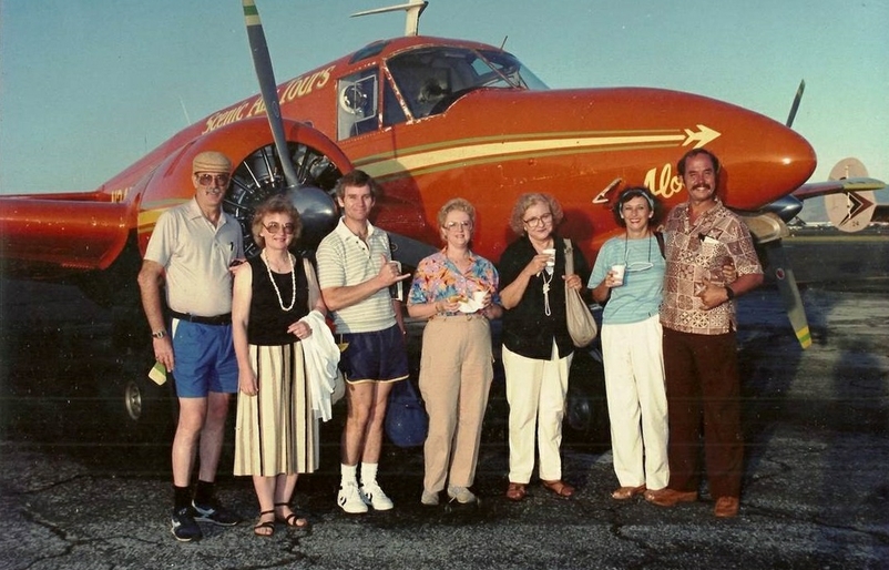 Rogers, pictured far right, when he was a pilot for a company called Scenic Air Tours. Capt. Rick