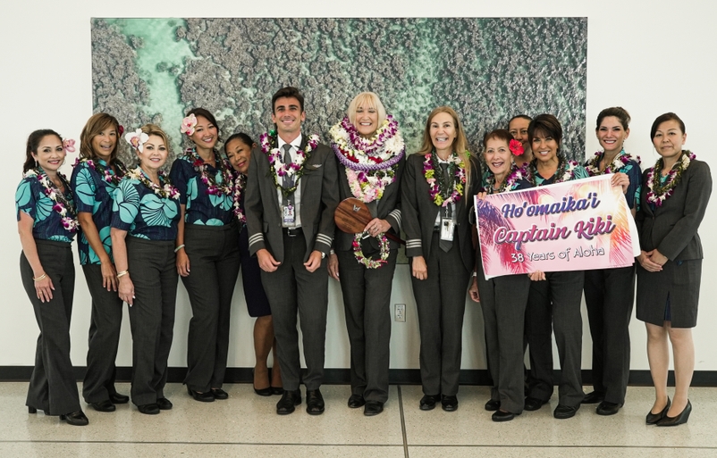 Capt. Kendall "Kiki" Culler, pictured in the center covered in lei, upon her arrival at the Daniel K. Inouye International Airport following her last flight DSC05333
