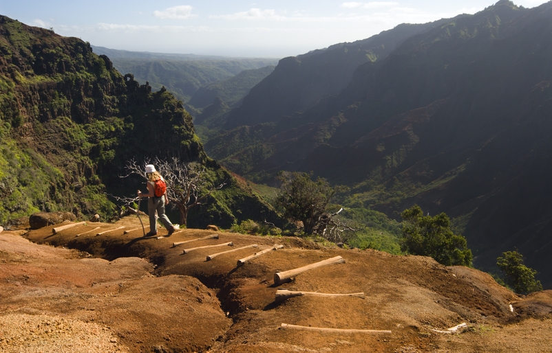 Guests can hike responsibly by researching the trail before going, heeding caution signs, carrying plenty of food and water, staying on the designated path, and maintaining a six-foot distance from other hikers. GettyImages-157396504
