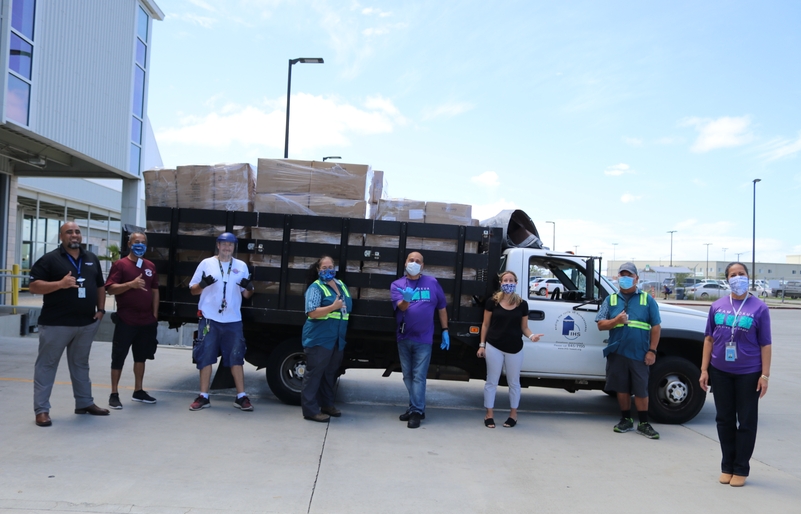Hawaiian employees and Institute for Human Services' staff in front of a truck filled at capacity with boxes of our Main Cabin blankets. IMG_3544