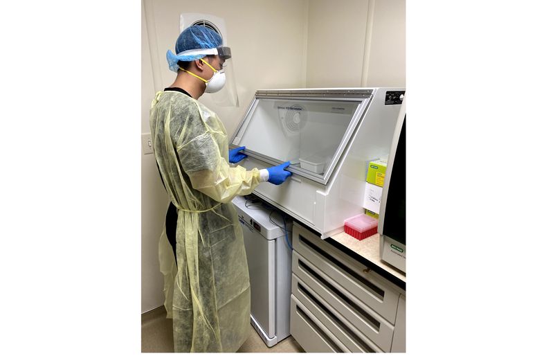 A Worksite Labs worker processing a COVID-19 test. Our dedicated labs are fully equipped to collect and process samples on-site and ensure timely results. IMG_8046