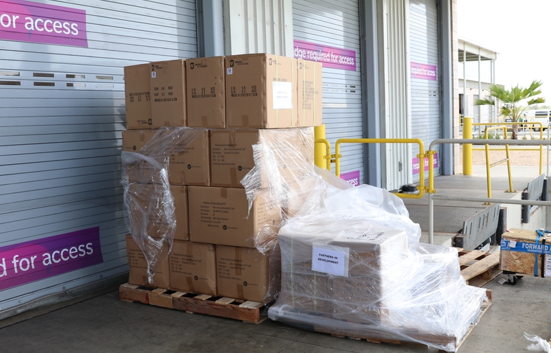 Boxes of soft goods waiting to be loaded onto a Partners in Development Foundation truck. Donations will support families and people in need during the COVID-19 pandemic. IMG_8673
