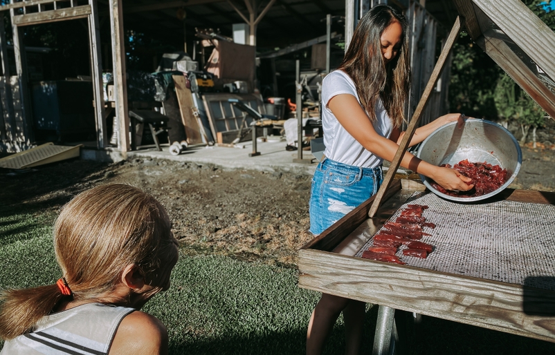 Kahoʻohanohano drying freshly caught fish at her ʻohana's hale (house) in Hilo. Hawaiian food (catering, specifically) is her family's expertise, and the memories of returning to Hilo and helping her ʻohana cook is often enhanced by their dedication to sharing ʻōlelo Hawaiʻi in the home. IMG_9353