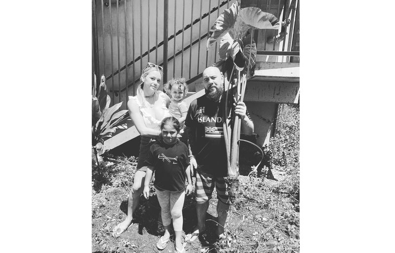 Rapozo with his ʻohana holding a kalo (taro) plant pulled from their māla (garden). Keola1