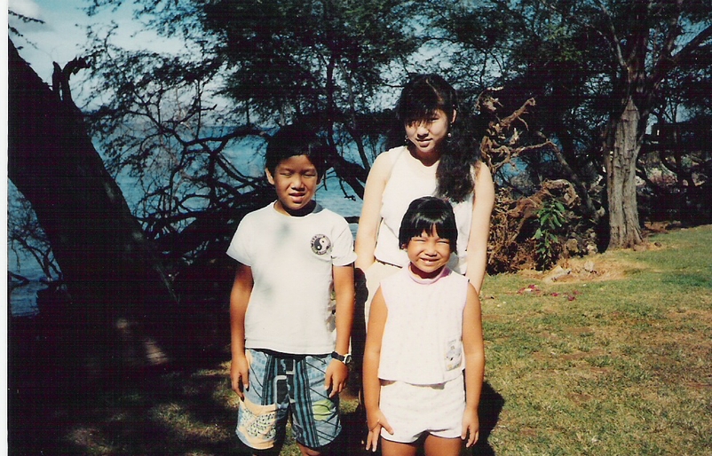 Okinaka, center, with her younger brother and sister in Hilo on Hawaiʻi Island Sha.tif and siblings circa 1990